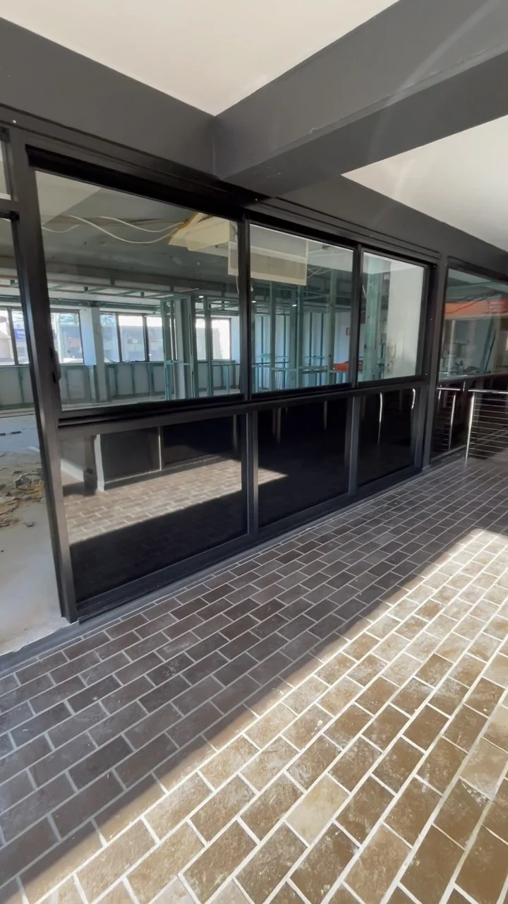 Black aluminium shopfront glazing during a commercial fitout in Terrigal