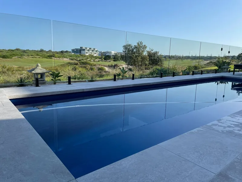 Frameless glass fencing around a swimming pool with an open outlook